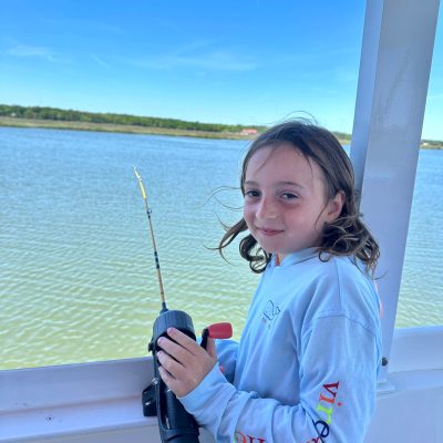 a person standing next to a body of water