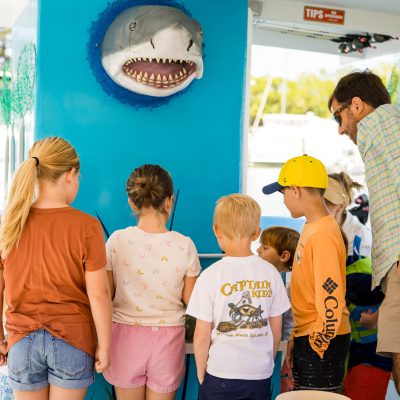 a group of people standing in front of a store
