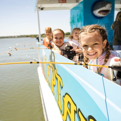 a person riding on the back of a boat