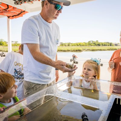 a group of people looking at a cake