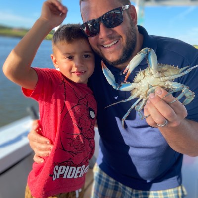 a hand holding a small child