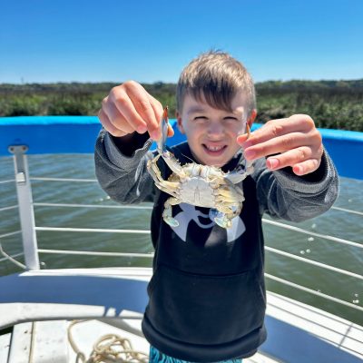 a little boy that is standing in the water