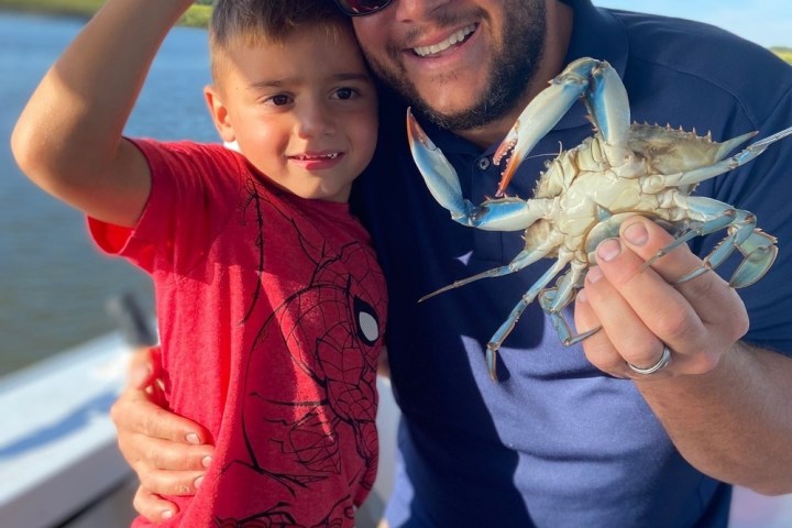 a hand holding a baby